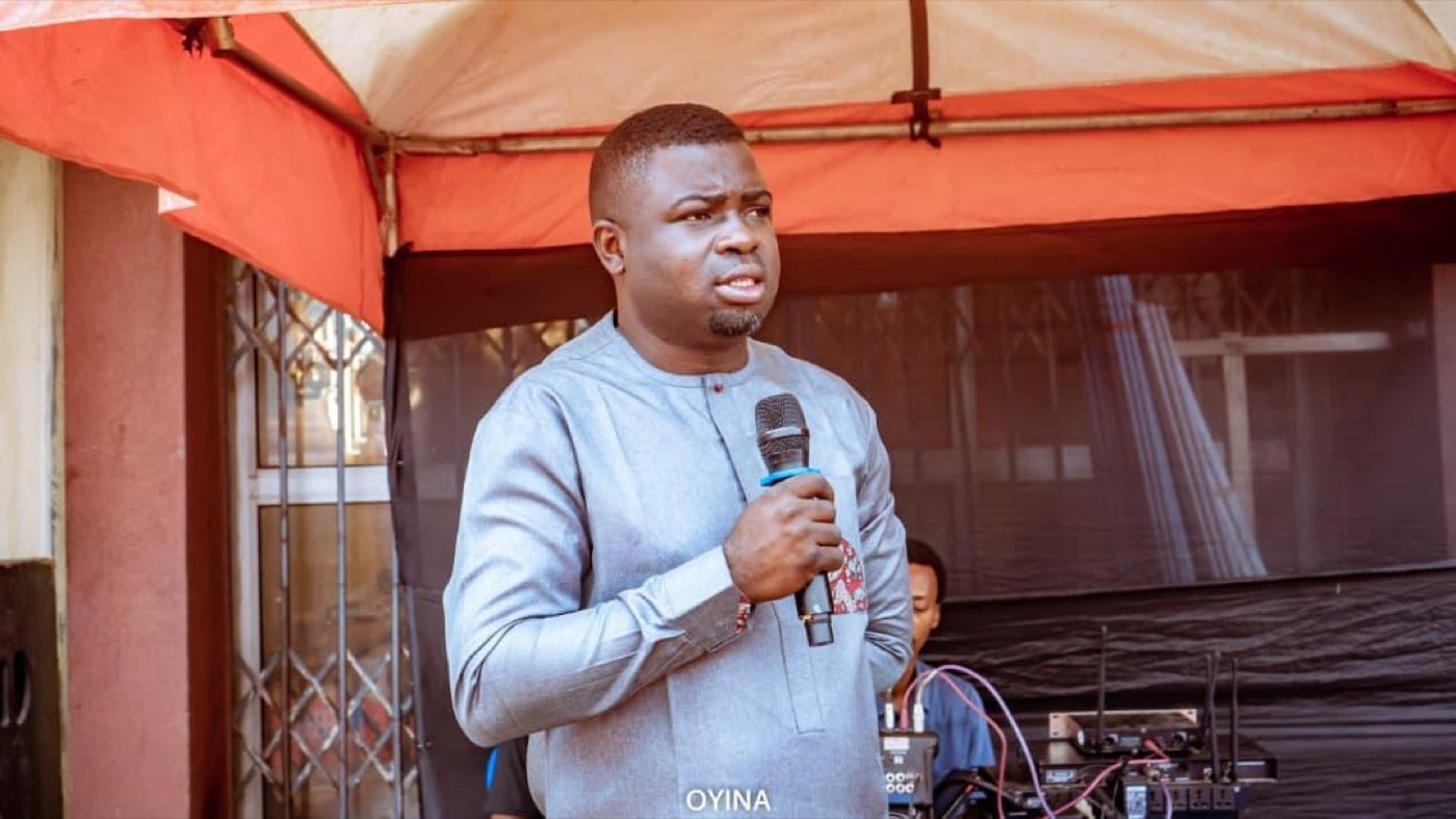 An OYNA representative speaking at an outdoor community event