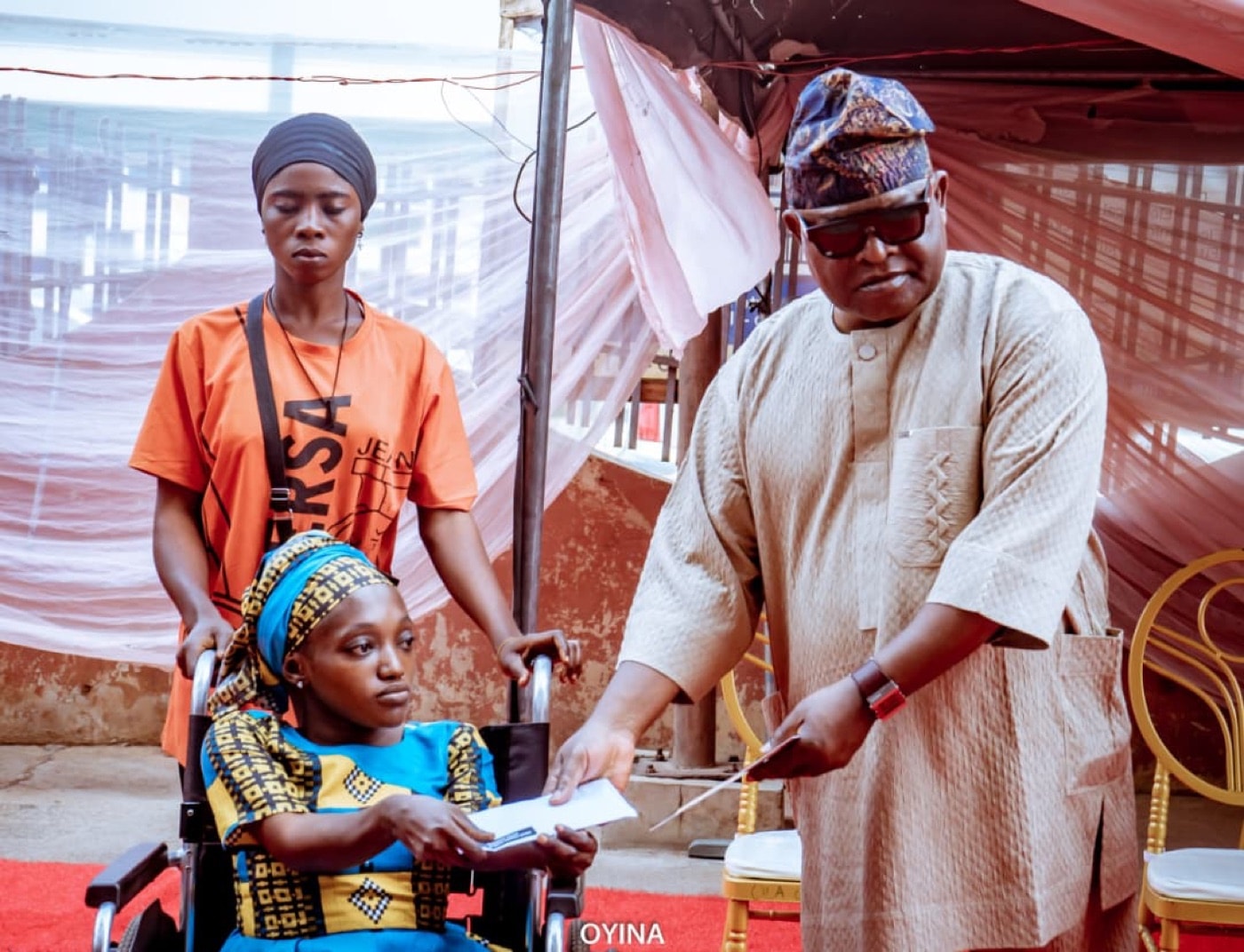 A community elder presenting an award to a participant